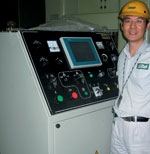 Robin Lu shows the control unit for one of the larger presses waiting to be shipped to a customer